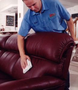 Technician Cleaning and Conditioning Leather Sofa